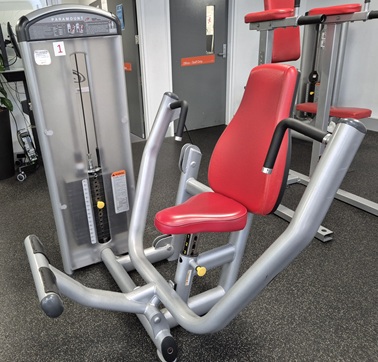 A chest press machine at the gym